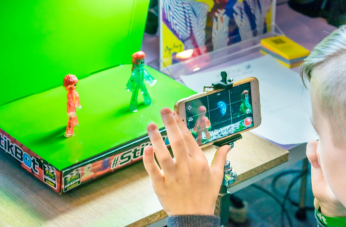 KROPIVNITSKIY, UKRAINE â€“ 12 MAY, 2018: Stop motion animation process with Stikbot details and toy figures. Boy expose stop motion elements to create animations using smartphone